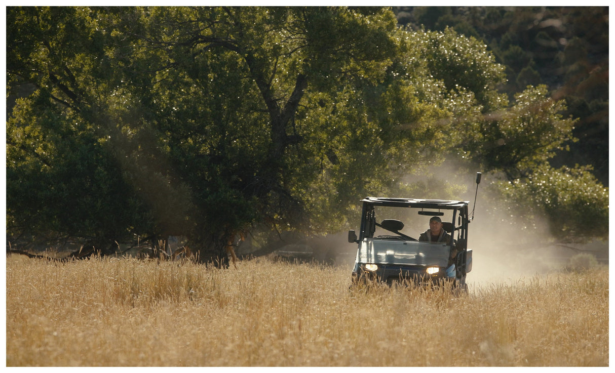Side by side with the weBoost SxS antenna crossing a dusty ranch field