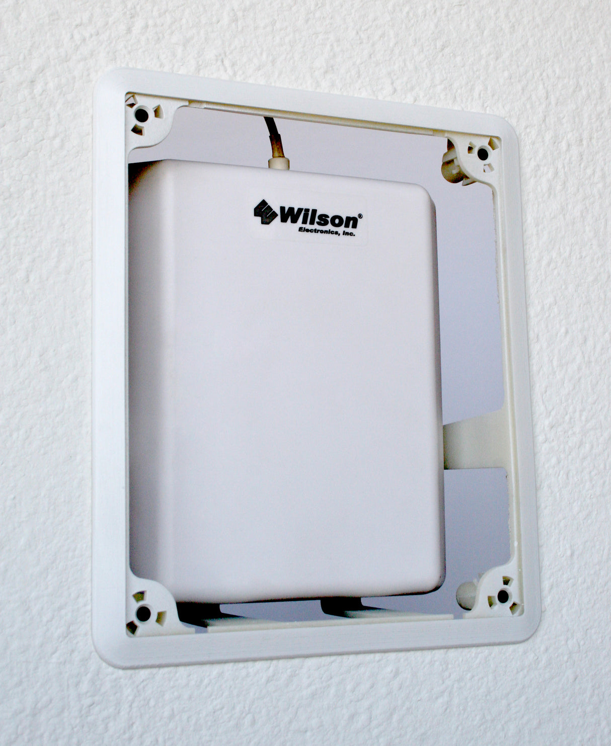 Installed in a wall with a panel antenna. Front cover not present.